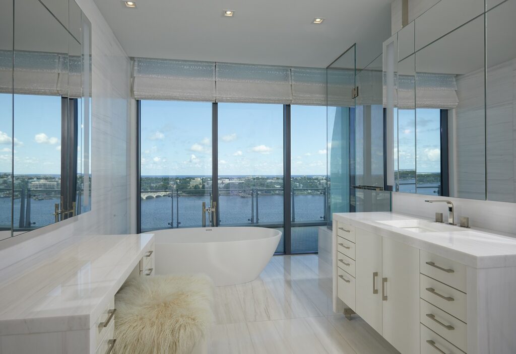Bathroom with a freestanding tub, stone vanity and waterfront views at Bristol Residence