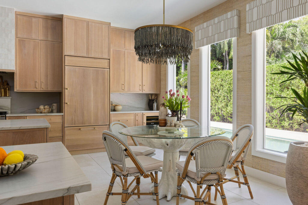 Wolfe Residence kitchen with pale wood cabinetry and stone countertops