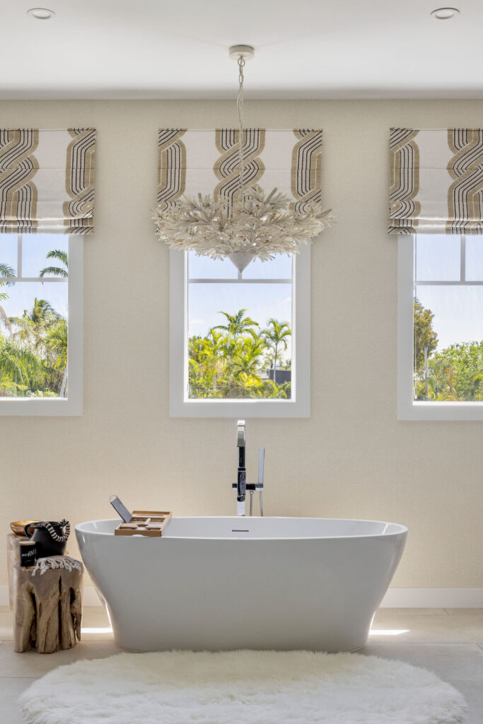 Freestanding bath, chandelier, and wall finishes at Wolfe Residence